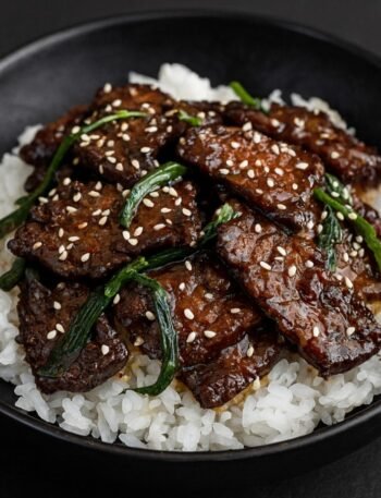 Crispy seared beef strips coated in a glossy soy garlic sauce with green onions.