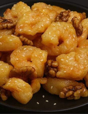 Golden fried shrimp coated in a creamy honey sauce and topped with candied walnuts.