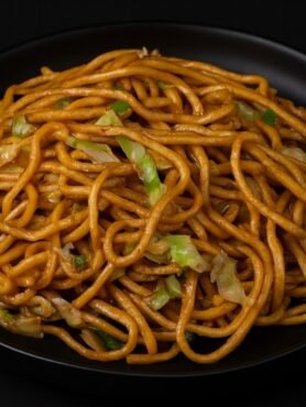 Stir-fried noodles with cabbage, onions, and celery tossed in a savory soy sauce.