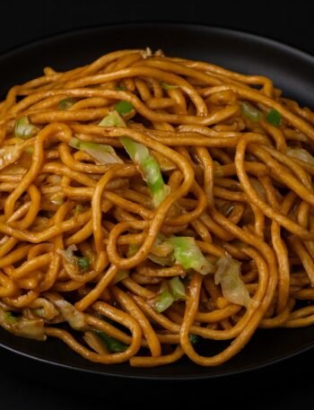 Stir-fried noodles with cabbage, onions, and celery tossed in a savory soy sauce.