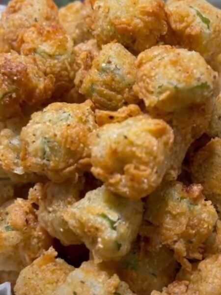 Golden fried okra pieces with a crunchy coating served in a bowl.